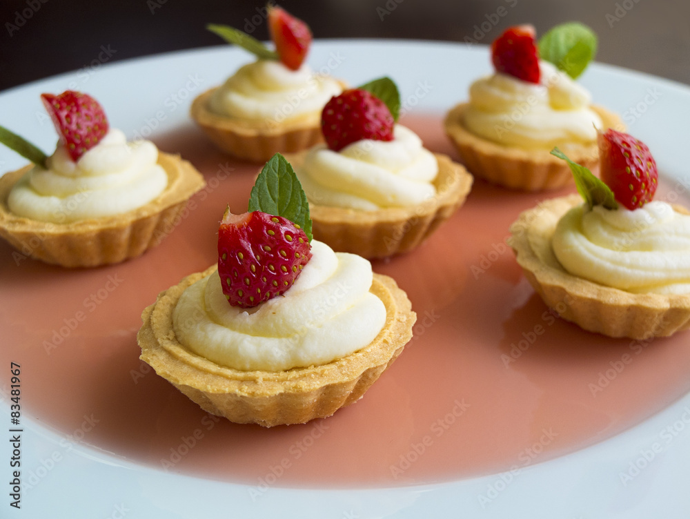 Tiny cupcakes with strawberry, whipped cream Tiny cupcakes with strawberry, whipped cream