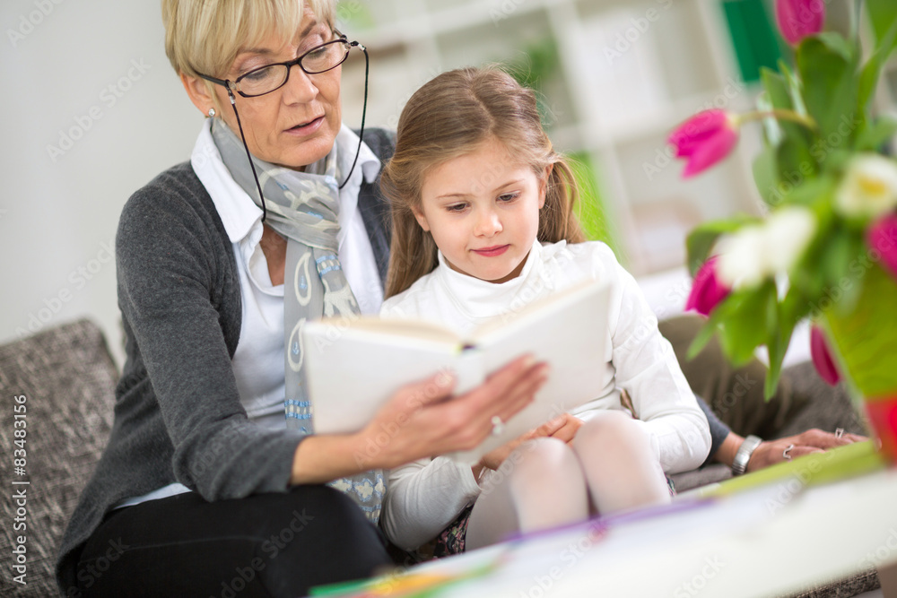 Grandmother and little girl reading book Grandmother and little girl reading book