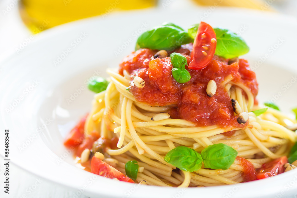 Spaghetti with tomato and basil leaves and chilli