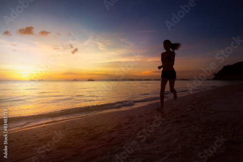 Silhouette of fitness woman jogging at sunrise