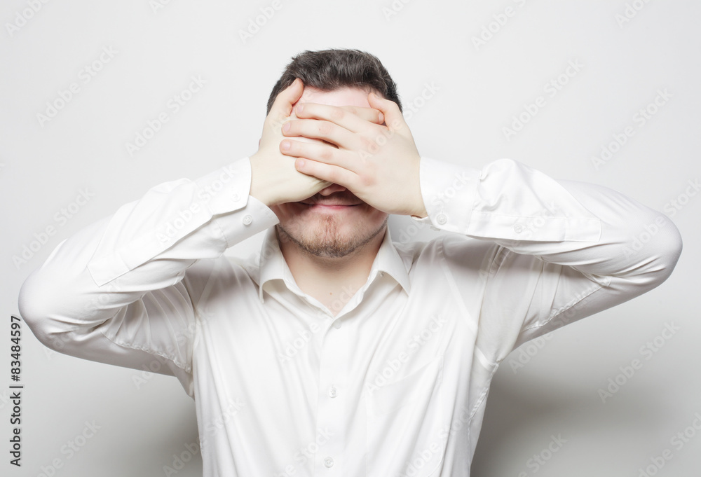 business man cover eyes with his hands business man cover eyes with his hands