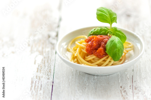 Spaghetti with tomatoes and fresh basil leaves