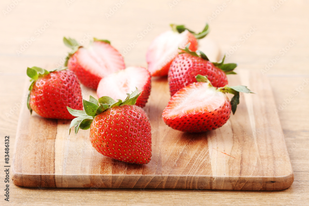 red fresh strawberry on wooden plate