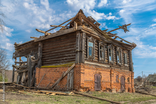  The old neglected wooden house is in a village © starets