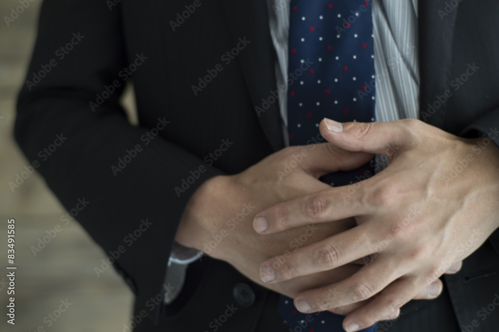 Businessmen are holding the stomach
