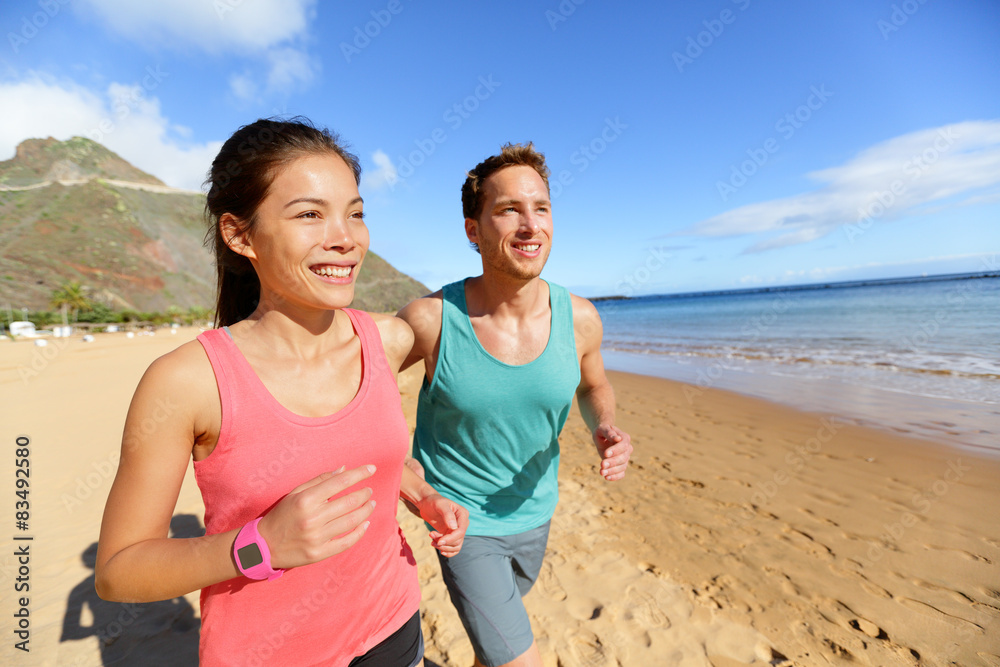 Running couple jogging on beach exercising Running couple jogging on beach exercising