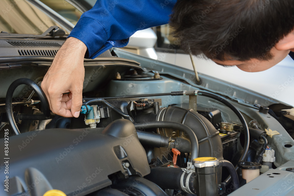Fototapeta premium Auto mechanic checking car engine