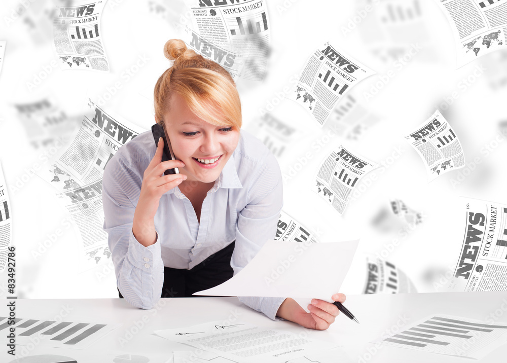 Business woman at desk with stock market newspapers Business woman at desk with stock market newspapers