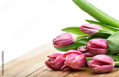 Pink tulips on a wooden background. Copy space