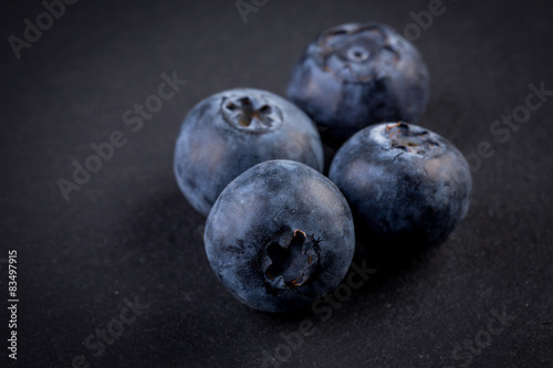 Blueberries on stone plate background