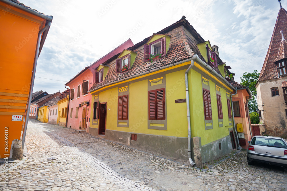 Stone paved old streets with colored houses from Sighisoara fort