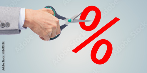 close up of businessman with scissors and percents