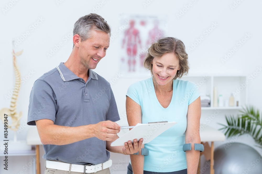 Obraz premium Woman using crutch and talking with her doctor