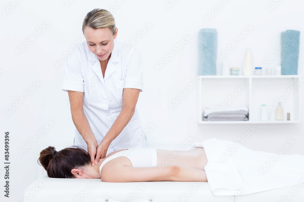 Physiotherapist doing neck massage Physiotherapist doing neck massage