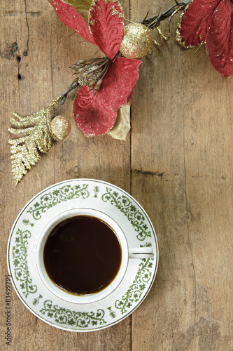 Coffee with red flower on wooden plank background © nattstudio