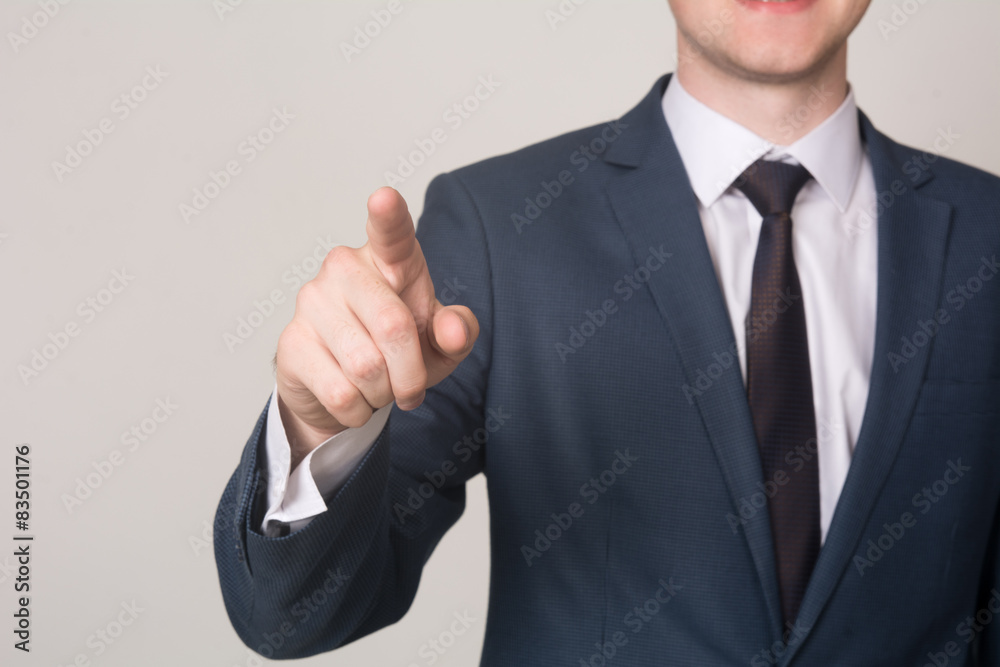 Close-up businessman hand pushing screen on light background Close-up businessman hand pushing screen on light background