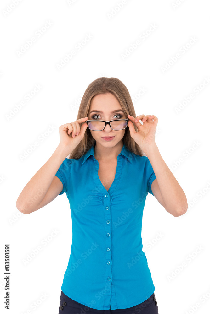 Beautiful young businesswoman in shirt adjusting her eyeglasses Beautiful young businesswoman in shirt adjusting her eyeglasses