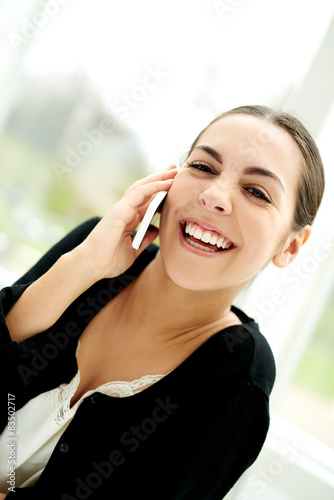 Pretty young woman chatting on her mobile photo