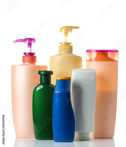  plastic bottles of body care and beauty products on white