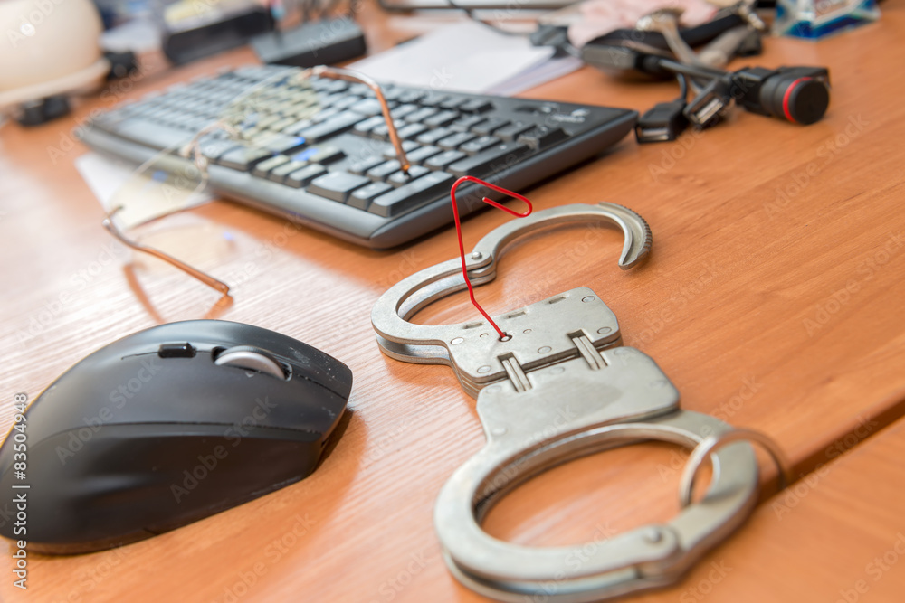 Handcuffs open paper clip on the table office worker Handcuffs open paper clip on the table office worker