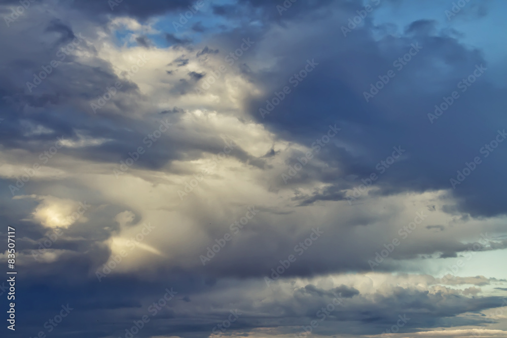 Sunlight is streaming through storm clouds