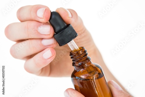 Woman holding bottle of medicine