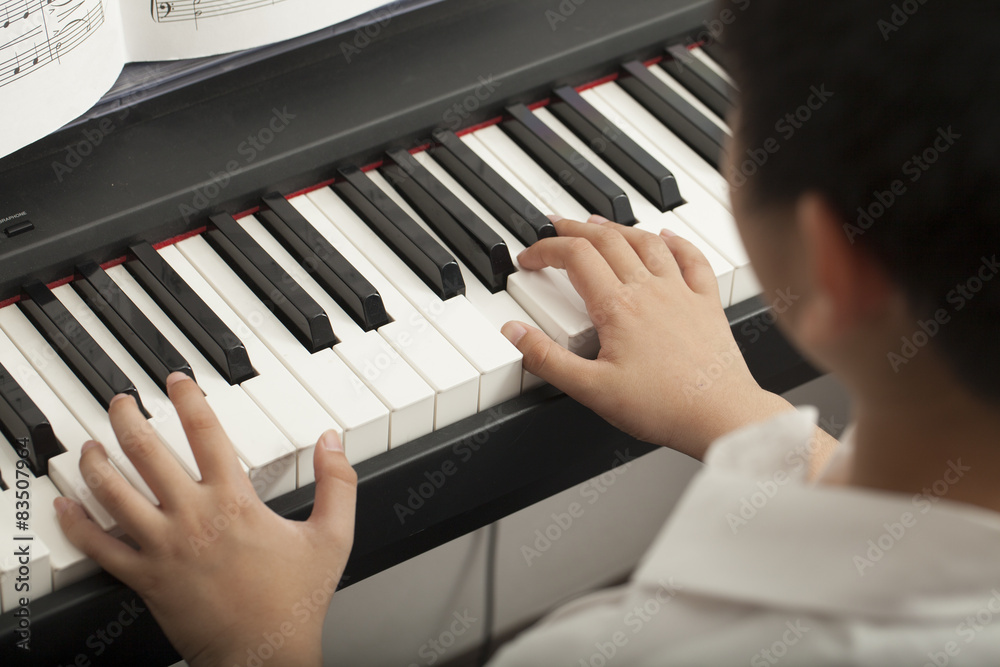Fototapeta premium piano lesson, Asian boy kid activity playing piano with notes