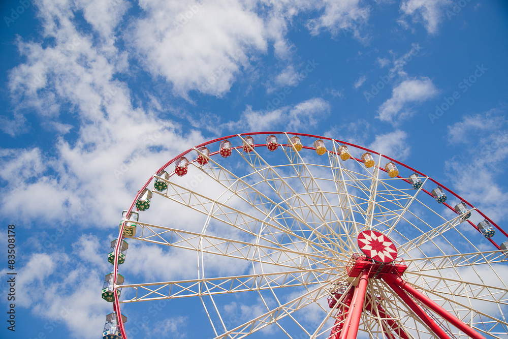 Atraktsion Ferris wheel against a blue sky
