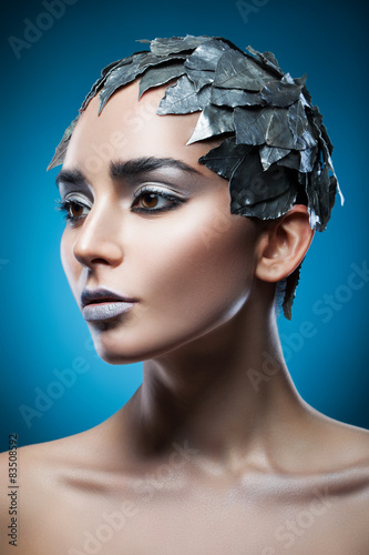 pretty woman in hat of silver leaves