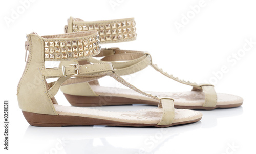 Beige sandals with studs on a white background 