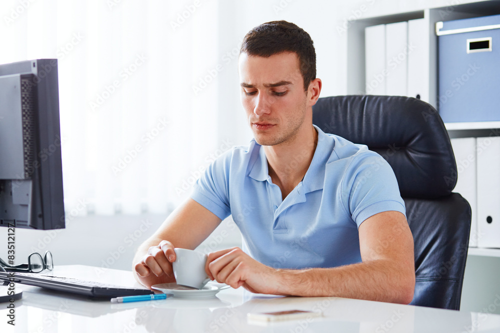 Man in office holding coffee Man in office holding coffee