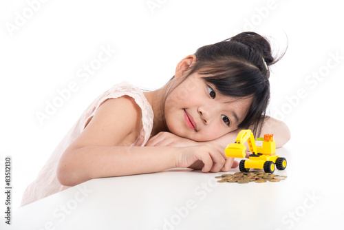 Little asian girl looking excavator toy  photo