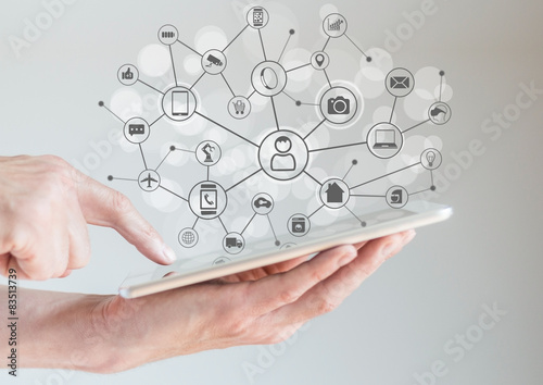 Internet of Things concept (IoT) with hand holding smart phone