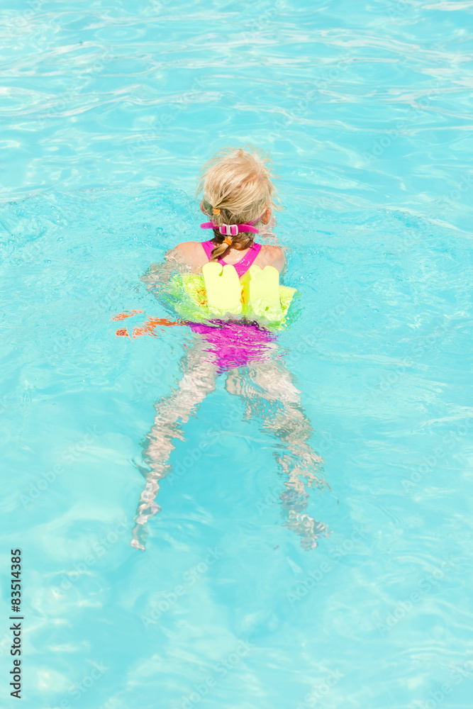 little girl swimming in the pool