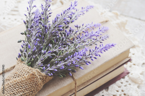 Fototapeta Naklejka Na Ścianę i Meble -  Decoration with lavender bunch upon vintage books bundle