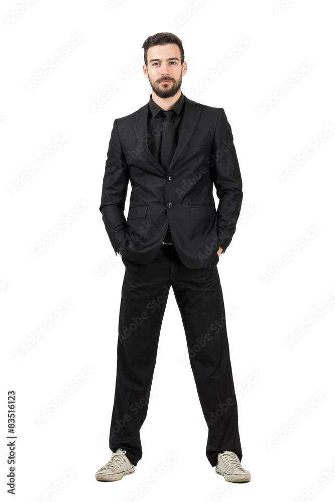 Smiling businessman with hands in pockets wearing sneakers Smiling businessman with hands in pockets wearing sneakers