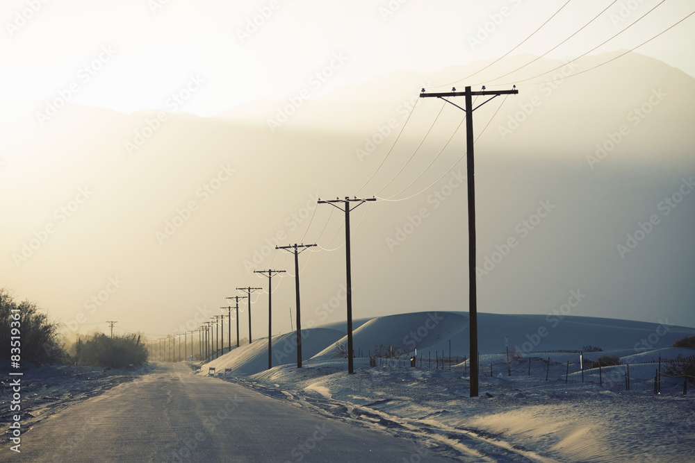 Power lines reaching into the distance, with a mountain backdrop. Power lines reaching into the distance, with a mountain backdrop.