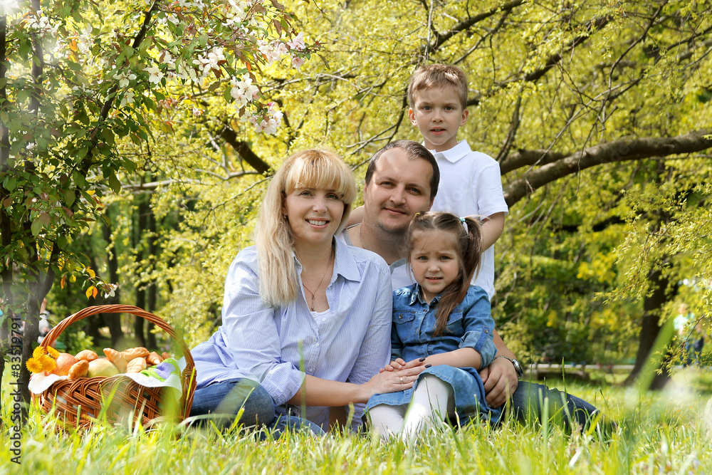 Beautiful family with kids having picnic outdoors Beautiful family with kids having picnic outdoors