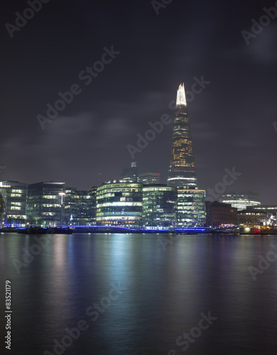 United Kingdom, London, Shard skyscraper illuminated at night and Thames river in foreground #83521179