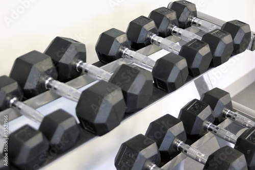 many dumbbells are at stand at the gym