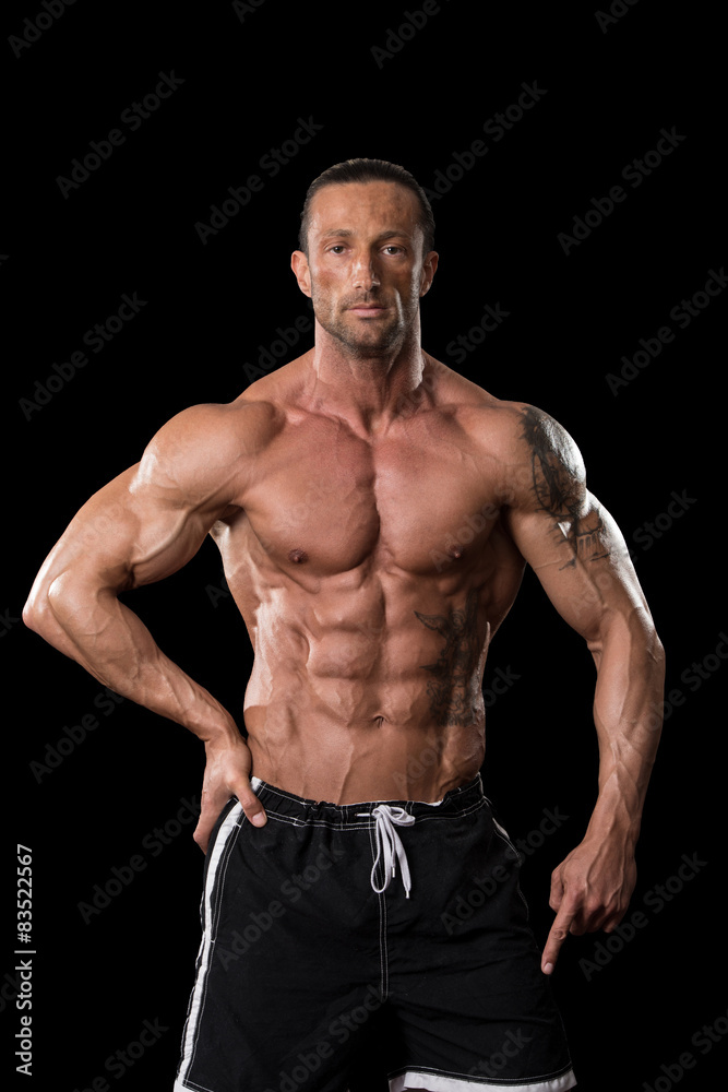 Muscular Bodybuilder Guy Posing Over Black Background