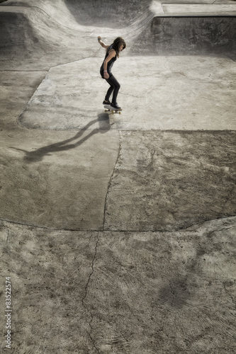 USA, Colorado, Hinsdale County, Lake City, Gril (12-13) skateboarding at skatepark photo