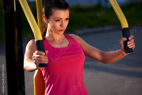 Woman focussed while exercising upper body.