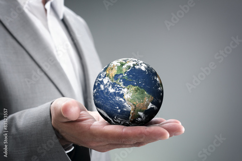 Fototapeta Naklejka Na Ścianę i Meble -  Businessman holding the world in his hands