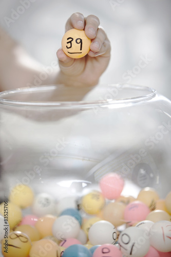 Hand selecting winning ball photo