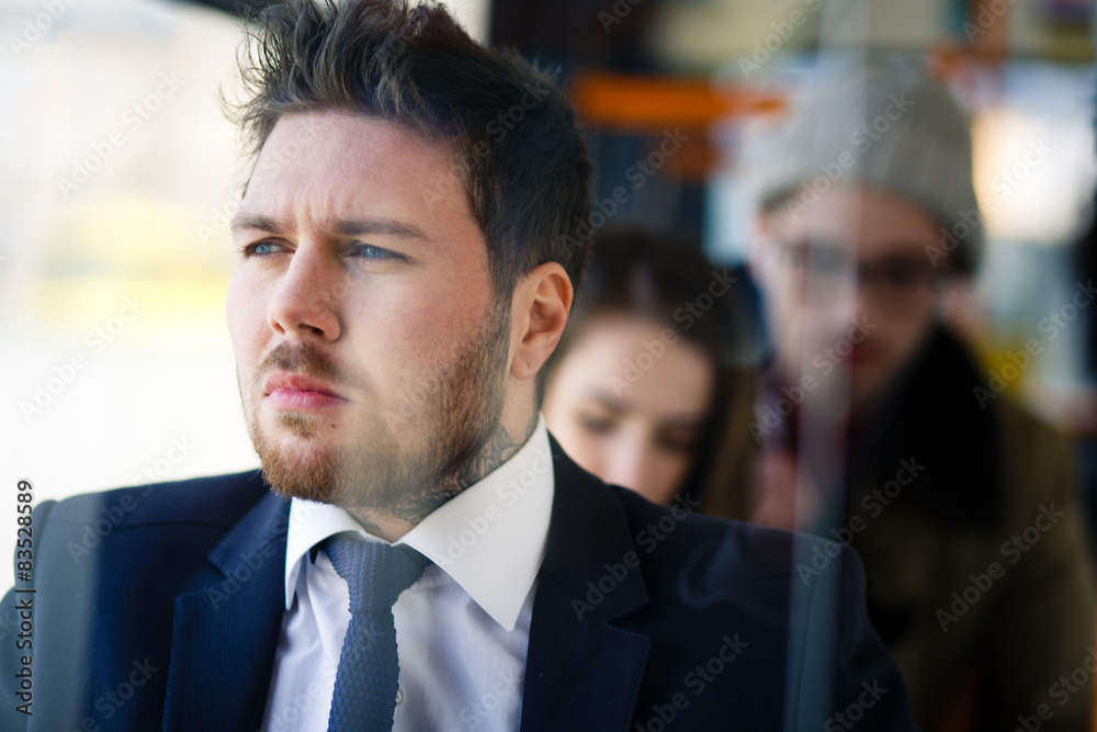 man in a suit on the bus