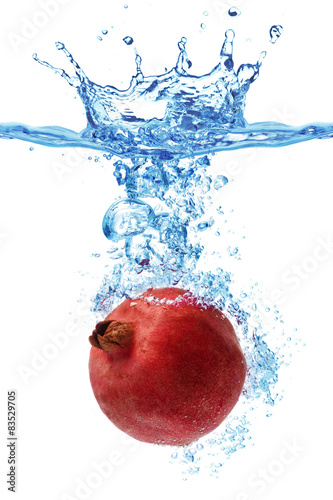 pomegranate splashing in water