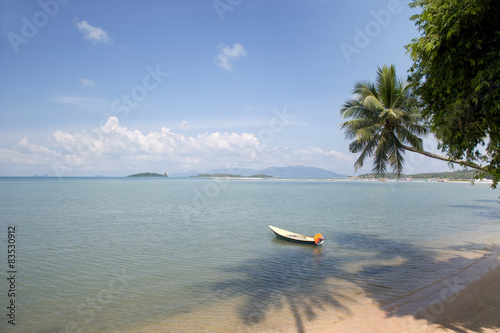 Boat moored on a tropical beach, Baan Thurian, Soi Nalat, Ko Samui, Thailand photo