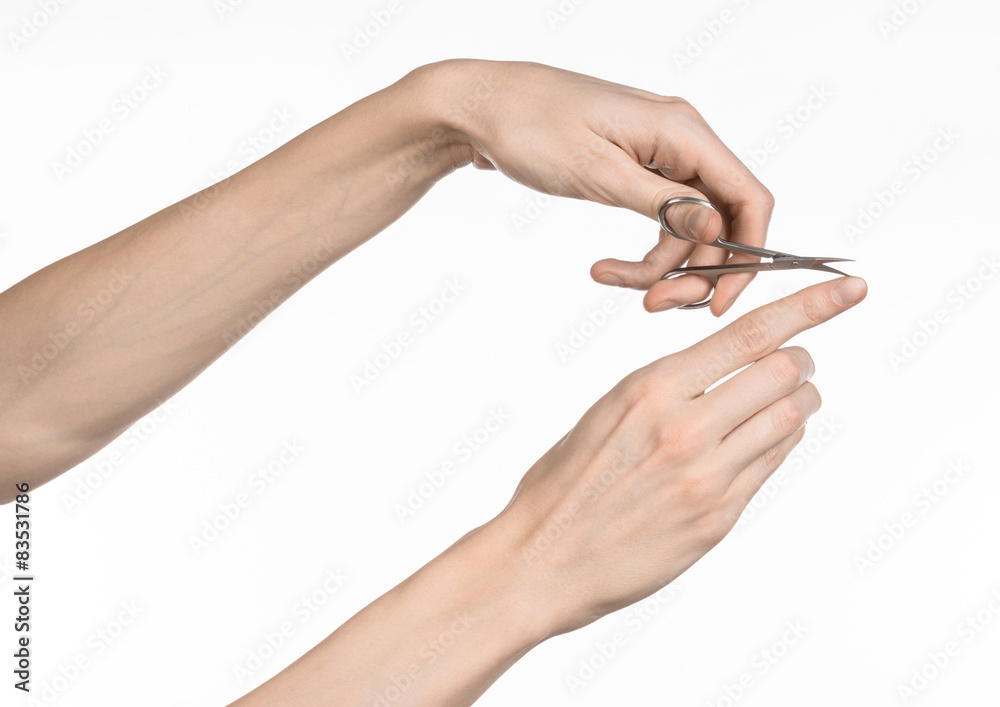 Hand holding scissors for manicure isolated on white background Hand holding scissors for manicure isolated on white background