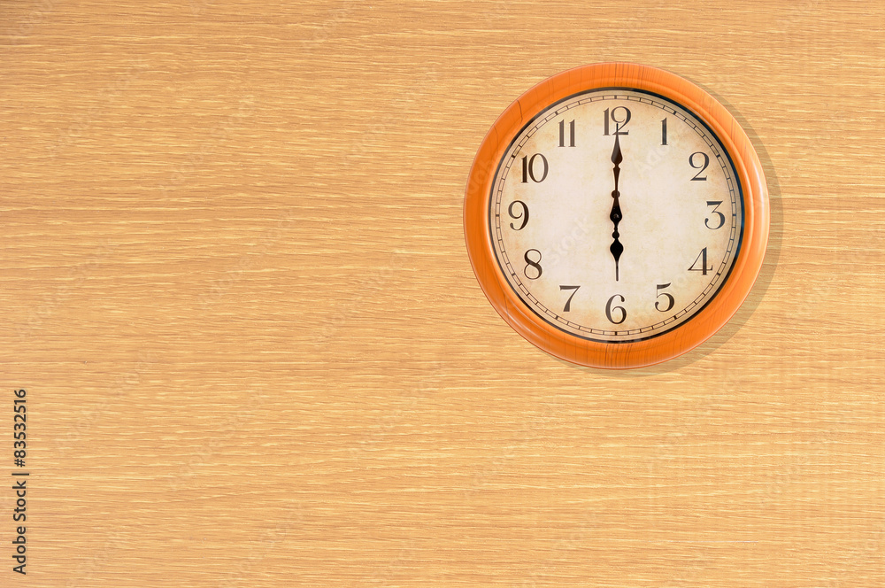 Clock showing 6 o'clock on a wooden wall Clock showing 6 o'clock on a wooden wall